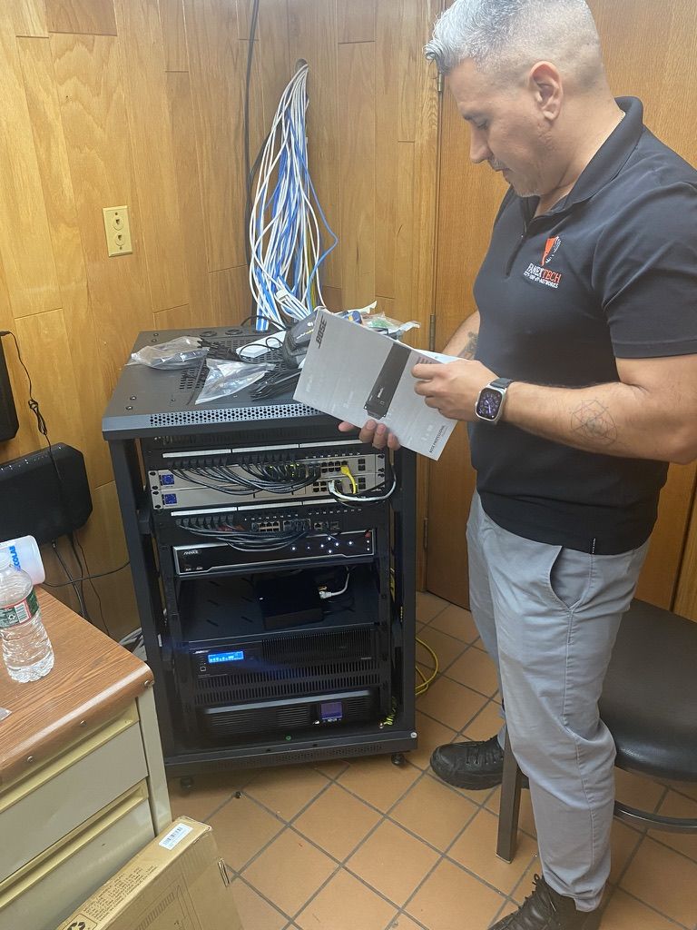 Juan, owner of Fanextech, setting up an equipment rack